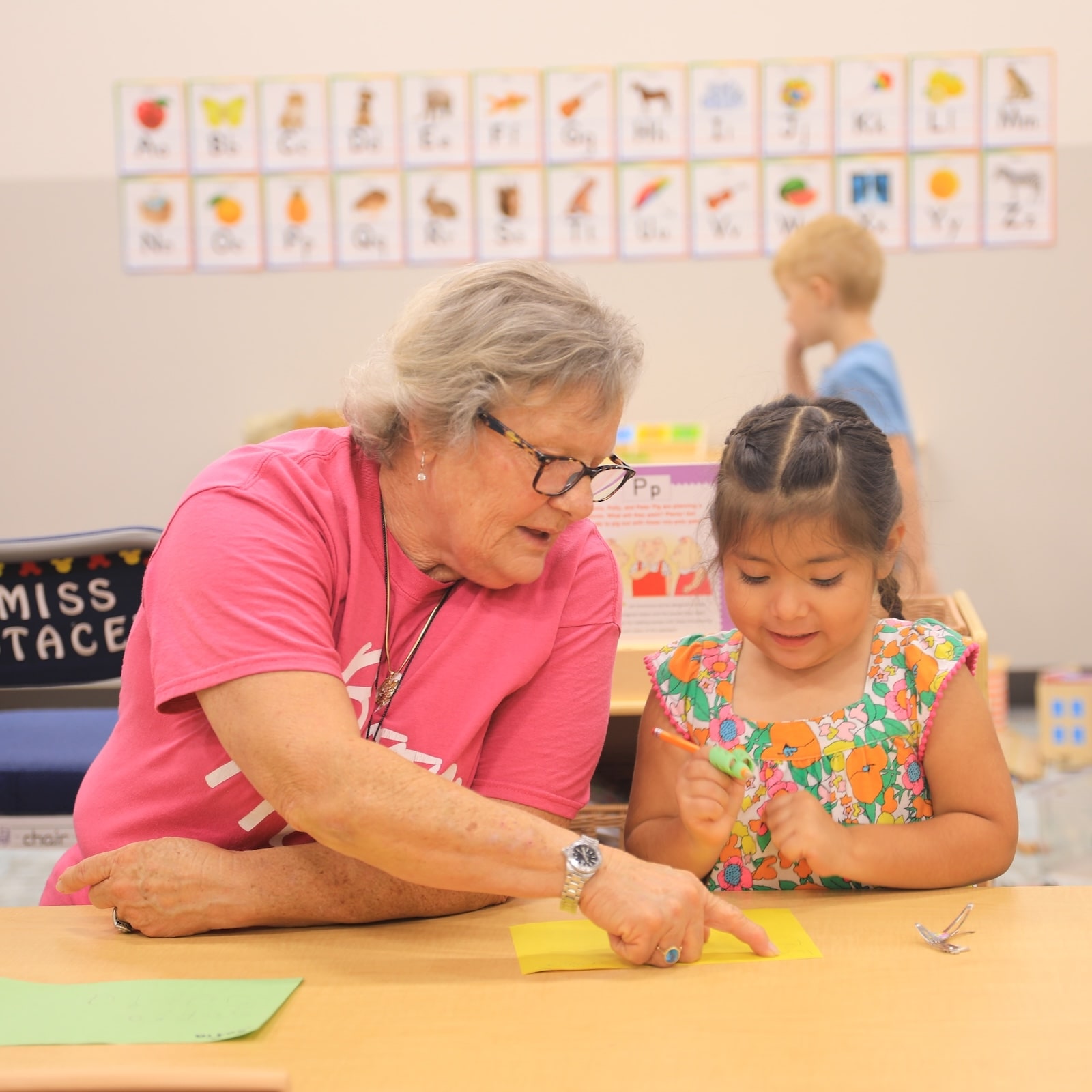 Bloom educator helping a child with an activity